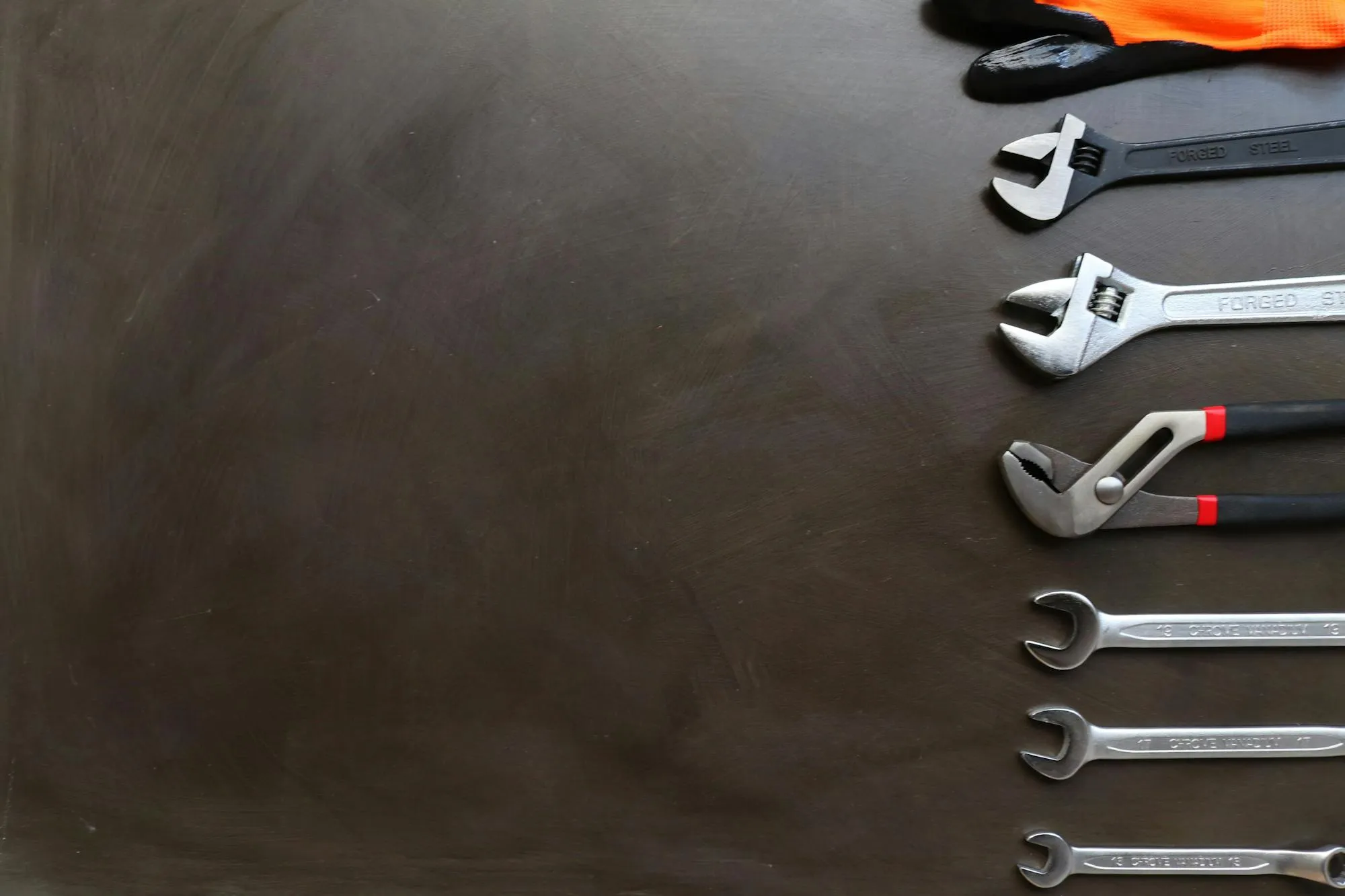 Plumber's toolkit laid out on a workbench in a Birmingham workshop